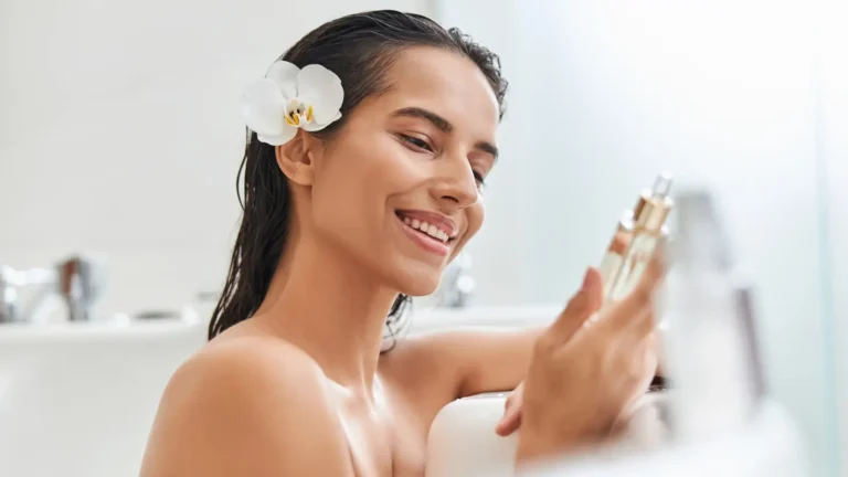 Elegant young woman sitting in a white bathtub filled with water, creating a serene and luxurious atmosphere
