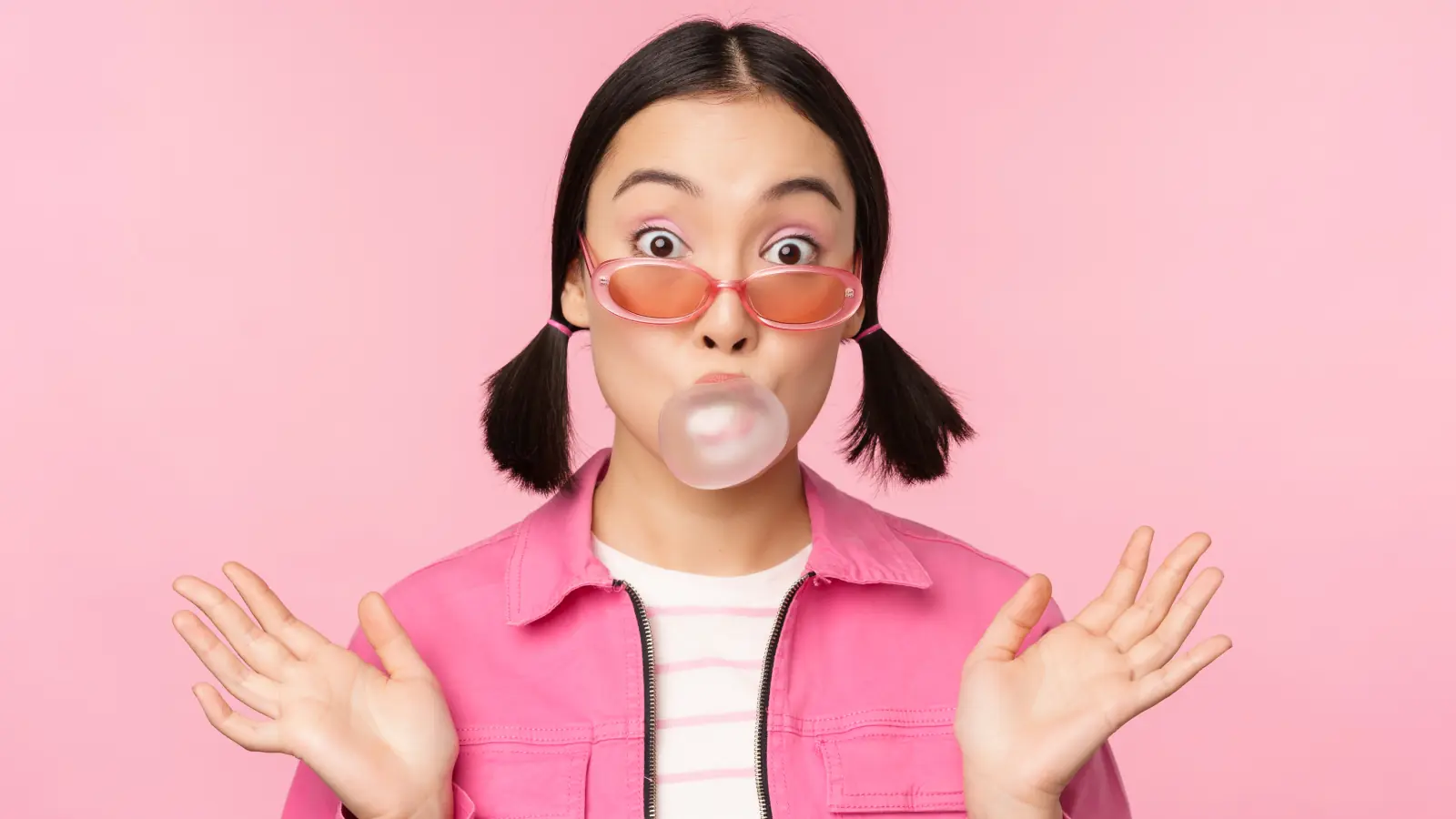 Portrait of a cheerful young woman with a bright smile, looking confident and happy, against a soft natural background.