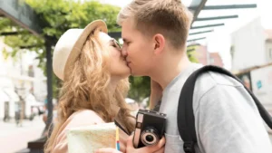 Young couple kissing with passion and affection outdoors, showing romantic love and emotional connection