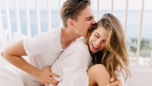 A young beautiful couple smiling and enjoying a tender moment together, showing love, trust, and emotional connection.